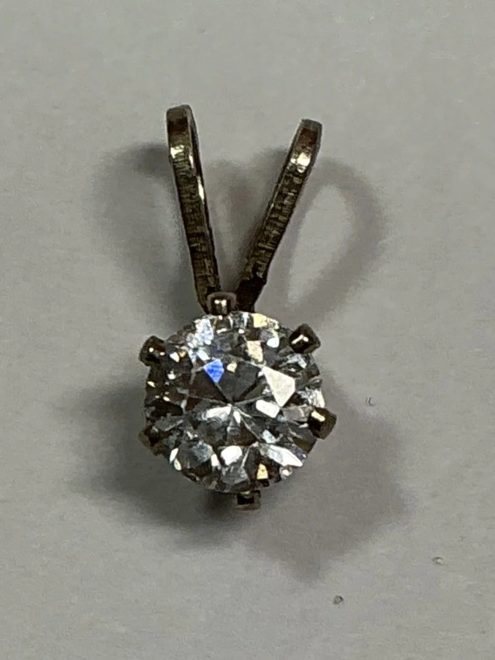Sterling Silver Petite Pendant with a clear stone. 1/2 inches long